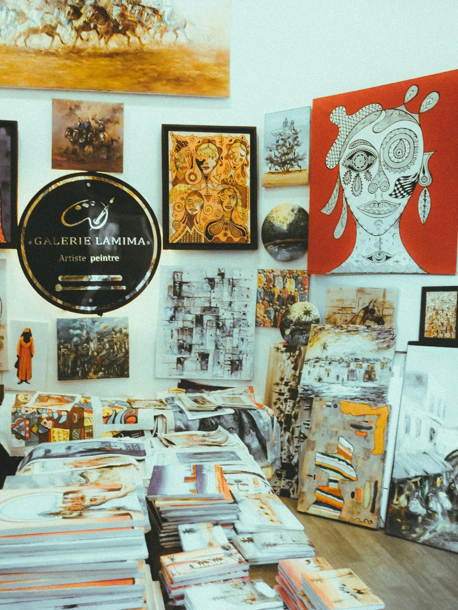 Diverse art collection in a gallery showcasing modern and abstract paintings.