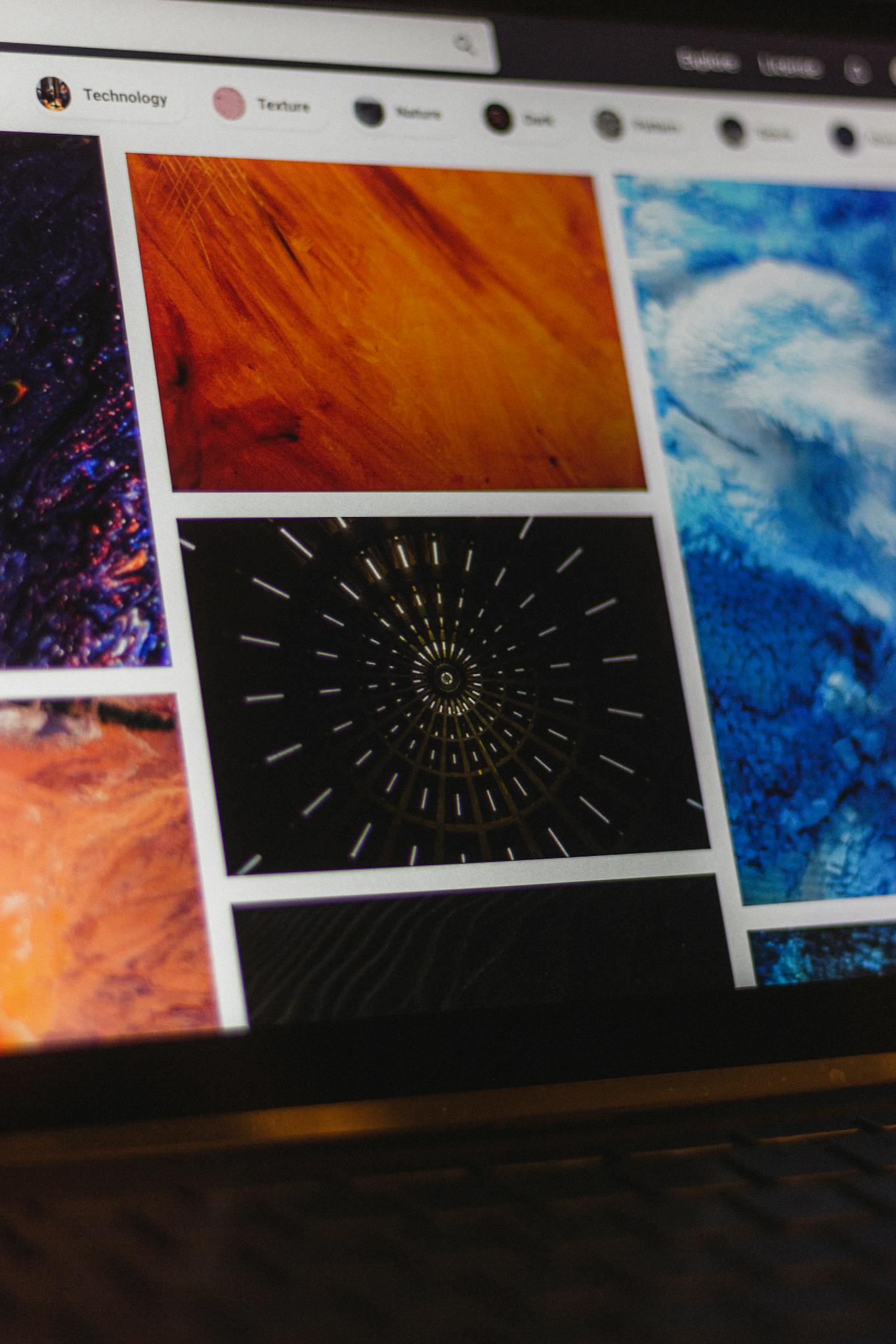 Portable computer with website representing assorted abstract photos under favorites and browser search engine with magnifier symbol